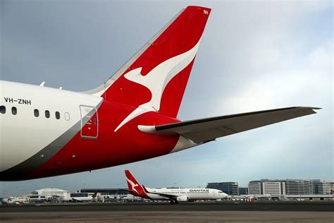 Qantas aircraft tail with iconic kangaroo logo against a blue sky