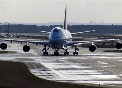 Qantas Boeing 747SP taxiing on wet runway in Sydney