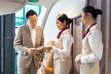 qantas female flight attendant welcoming passenger at boarding gate