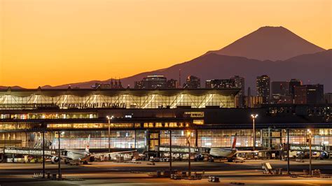 qantas jet taking off from tokyo haneda airport with mt fuji in background