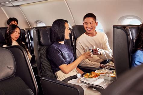 Qantas premium economy passenger sleeping with leg rest extended