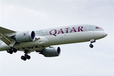 qatar airways 787-9 climbing after takeoff over desert skies