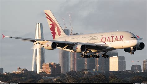 Qatar Airways A380 aerial view cruising above clouds golden sunrise