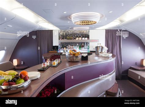 Qatar Airways A380 onboard lounge bar illuminated night flight passengers socializing