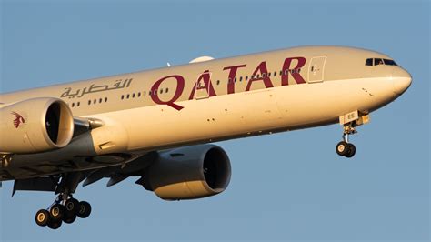 Qatar Airways Boeing 777-300ER parked at JFK gate during boarding