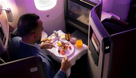 Qatar Airways business class dine-on-demand meal service with premium table setting