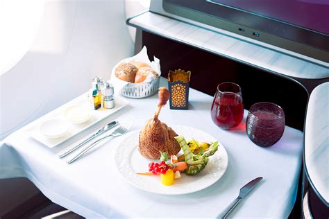 Qatar Airways business class dining inside QSuite private cabin