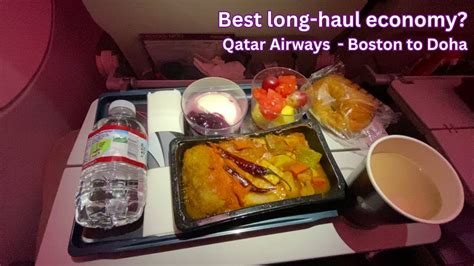 Qatar Airways long-haul economy dinner tray with wine and multiple meal components