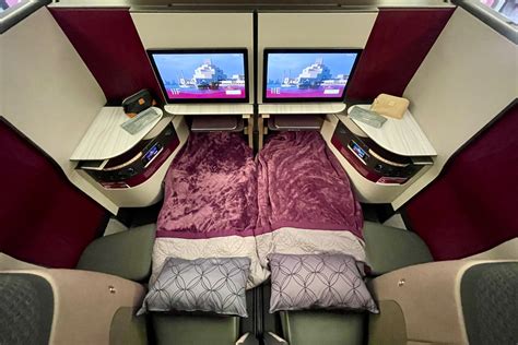 Qatar Airways QSuite double bed configuration Boeing 777 cabin