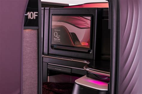 Qatar Airways Qsuite Next Gen quad suite private cabin OLED screens luxury interior