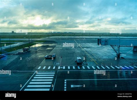 Rainy tarmac at Bali airport with stranded passengers seeking shelter