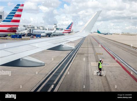 ramp agents servicing aircraft at Miami International Airport