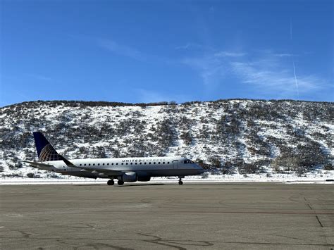regional jet approaching Aspen-Pitkin County Airport with snow-covered Rocky Mountains