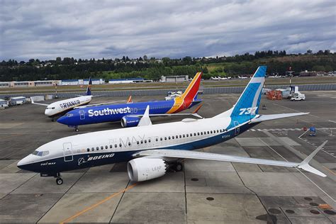 regional jet parked beside Boeing 737 MAX at US airport gate