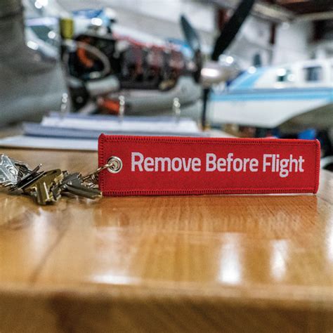 remove before flight tags hanging from multiple aircraft safety pins during maintenance