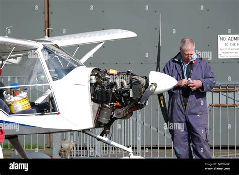 Repairman working on Rotax engine of E-LSA aircraft in private hangar