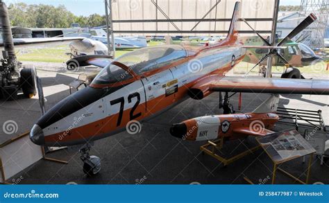 restored fighter jet displayed inside military aviation museum