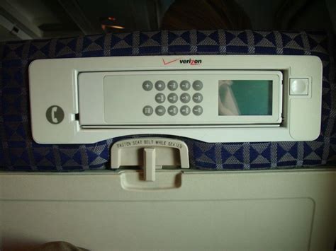 retro airfone handset installed in airplane seatback for passenger calls