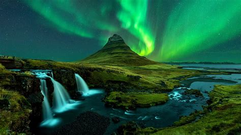 Reykjavik skyline with Icelandair and Air India planes in flight during northern lights