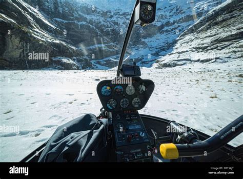 Robinson R44 cockpit avionics panel with mountain backdrop