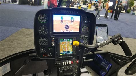 Robinson R66 cockpit with dual-control configuration and optional digital avionics, photographed in a Canadian training facility in 2023