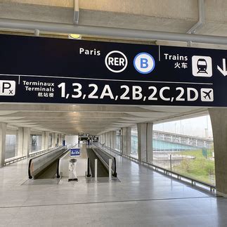 Roissybus boarding at CDG Terminal 2 with labeled sign to Paris Opera