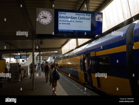 rotterdam centraal station with travelers boarding train to amsterdam