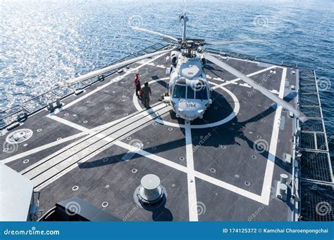 Royal New Zealand Navy frigate with deck crew preparing for helicopter landing