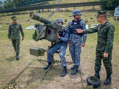 Royal Thai Air Force officers inspecting Gripen E during defense exhibition in Bangkok