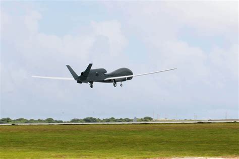 RQ-4 Global Hawk high altitude surveillance drone cruising above earth horizon