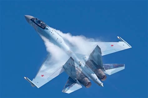 Russian Su-35 Flanker fighter jet accelerating through clear blue sky