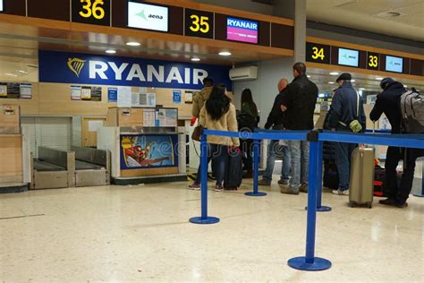 Ryanair airport check-in counter with passengers waiting