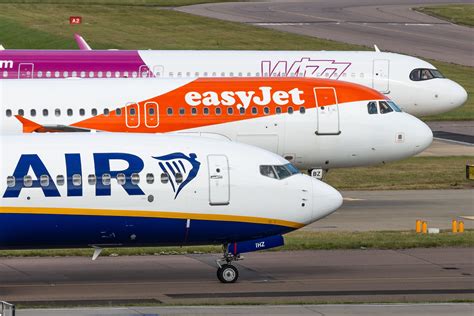 Ryanair and easyJet planes parked at Stansted Airport in peak summer season