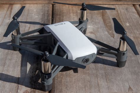 Ryze Tech Tello drone resting on wooden floor with tablet nearby