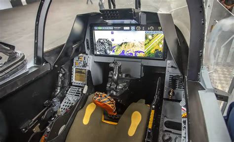 Saab technician demonstrating Gripen cockpit features to Philippine Air Force personnel in Manila