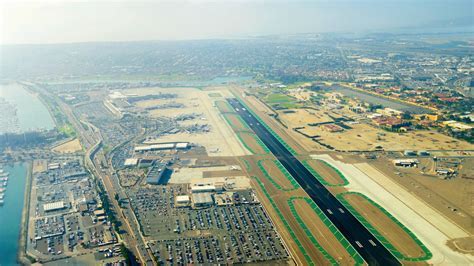 San Diego International Airport single runway with downtown skyline backdrop