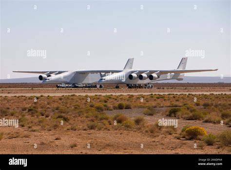 Scaled Composites Stratolaunch Roc carrying a rocket between twin fuselages