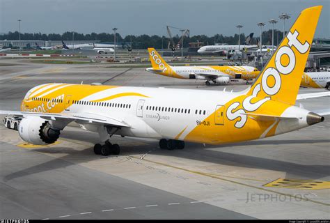 Scoot Boeing 787 Dreamliner aircraft with yellow livery flying above clouds