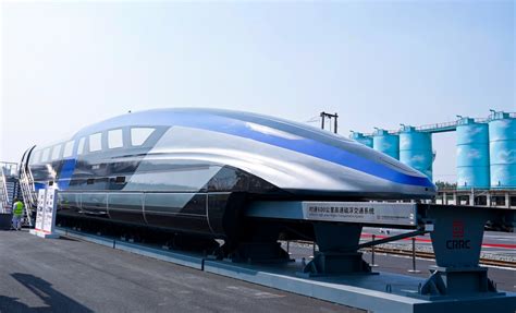 Shanghai Maglev crossing elevated track with Pudong skyline in background