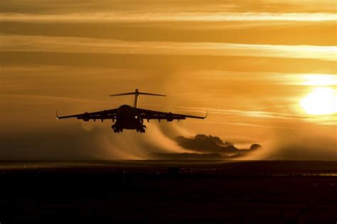 Silhouette of a Boeing C-17 Globemaster III aircraft at sunset over a Texas airfield