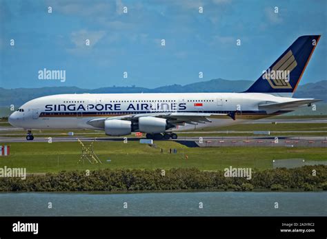 Singapore Airlines A380 taxiing at an airport with premium economy passengers boarding