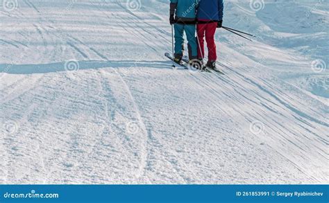 Skiers riding up T-bar lift on a sunny day at Glenshee