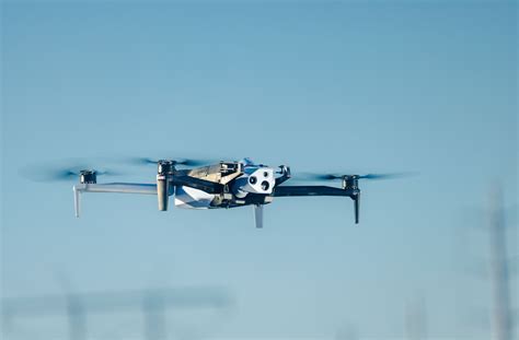 Skydio drone hovering autonomously in mountain recon scenario