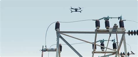Skydio X10 inspecting high-voltage power line in remote terrain