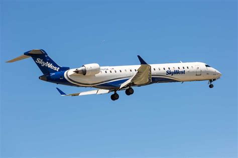 skywest regional jet on snowy runway preparing for departure