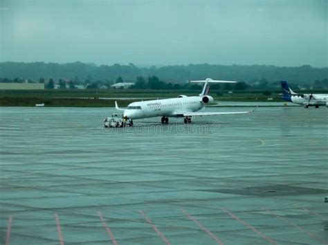 small regional jet on rainy tarmac