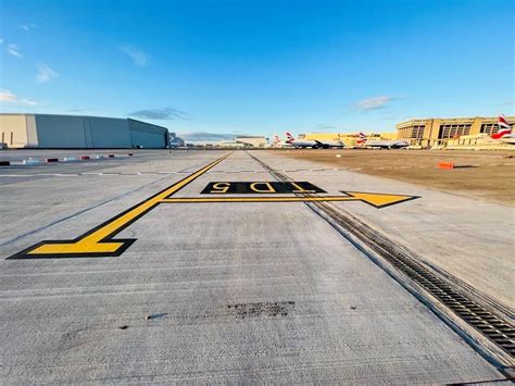 small terminal building and apron at Pilot Point Airport with cargo unloading