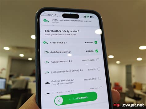 Smartphone screen displaying Grab app booking a ride in Hanoi