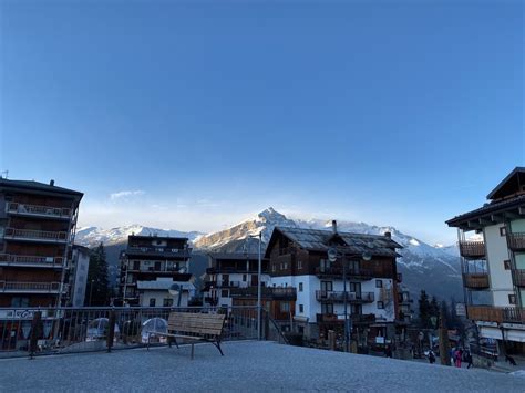Snow-covered rooftops and distant peaks in Sauze d’Oulx village