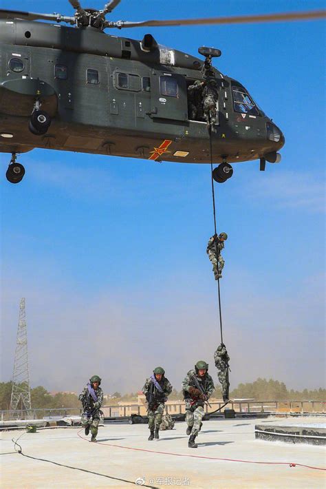 soldiers fast roping from modern tiltrotor aircraft side doors during combat insertion exercise
